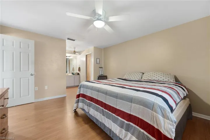 Bedroom with ceiling fan and wood-type flooring