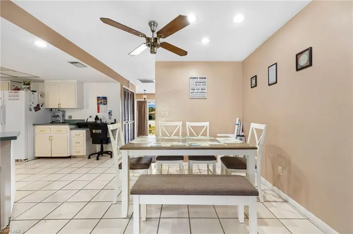 Dining area featuring ceiling fan and light tile patterned floors