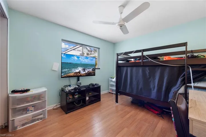 Bedroom featuring wood-type flooring and ceiling fan
