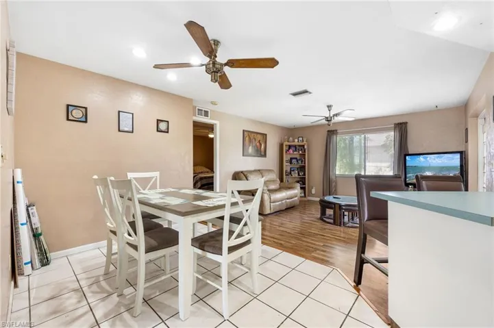 Dining space with ceiling fan and light hardwood / wood-style flooring