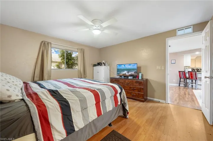 Bedroom featuring ceiling fan and light hardwood / wood-style floors