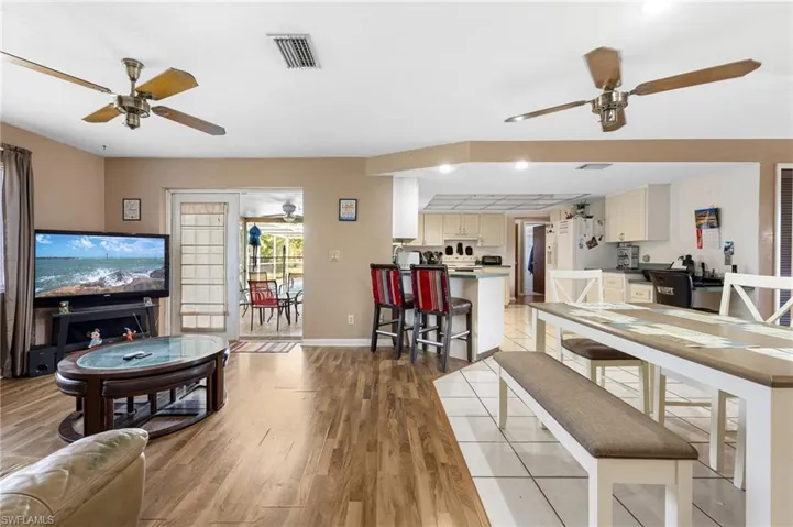 Living room with light wood-type flooring and ceiling fan