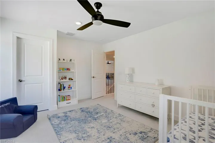 Bedroom featuring light carpet, ceiling fan, and visible vents