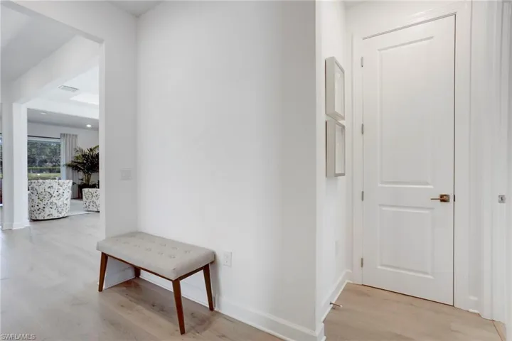 Hallway featuring baseboards and light wood finished floors
