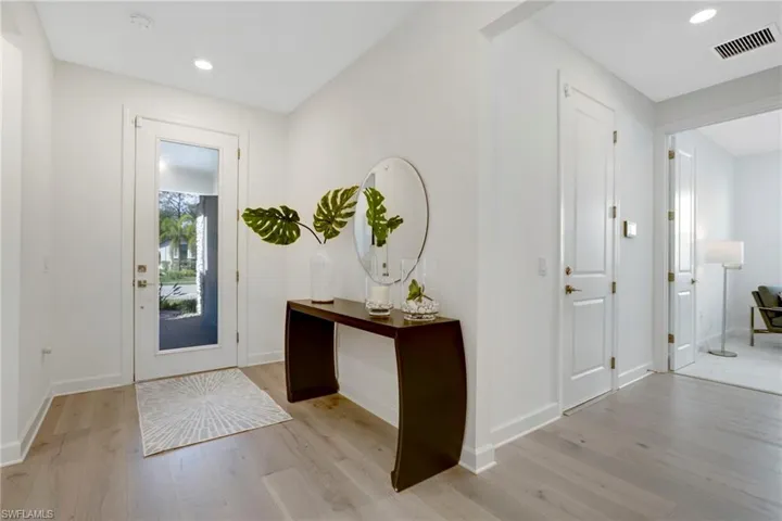 Entryway featuring recessed lighting, visible vents, light wood-style flooring, and baseboards
