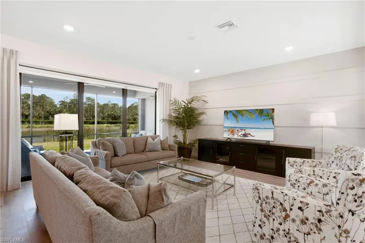 Living area with light wood-style flooring, visible vents, and recessed lighting