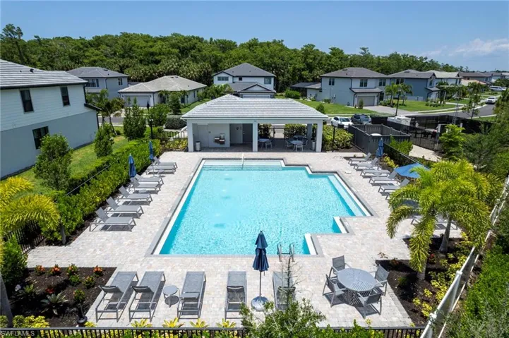 Community pool with a gazebo, a patio, and fence