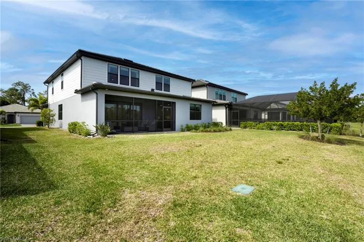 Back of house with a lawn