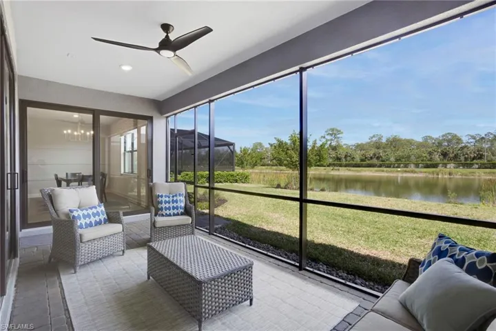 Screened-in Lanai with ceiling fan and a water view