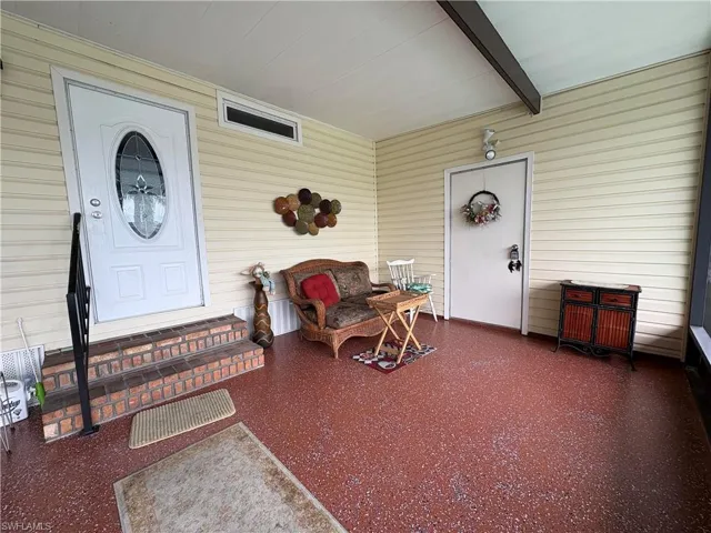 View of front screened lanai with entry door