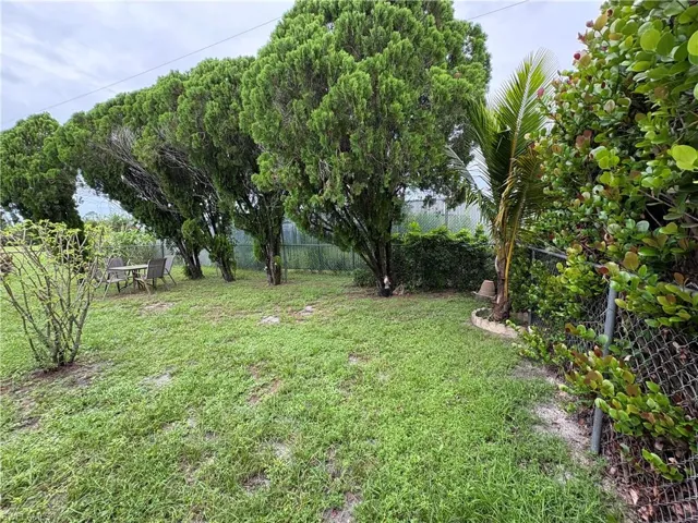View of large fenced rear yard with NO other homes behind, just a schrub line