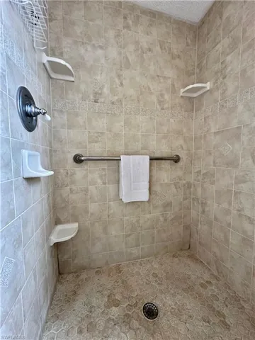 View of Primary Walk in Full bath walk in shower with tiled to ceiling shower