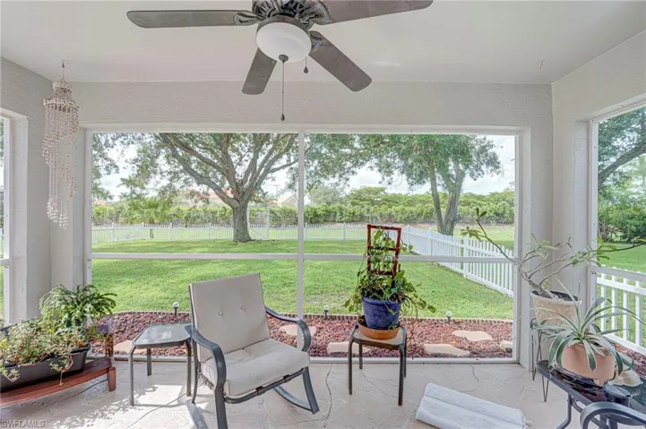 Screened in lanai overlooking fenced backyard.