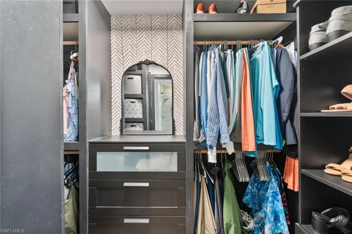 Primary bedroom walk-in closet with great built in system.