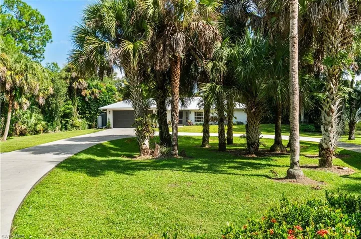 Private drive into property featuring a long, circular driveway.