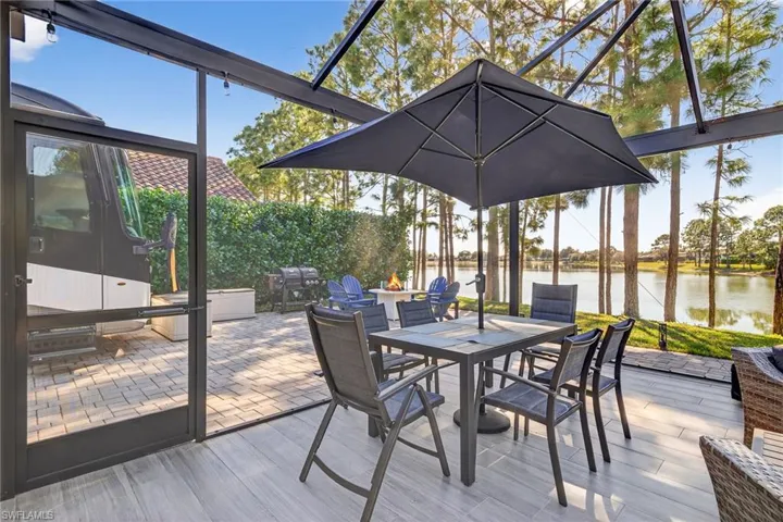 Sunroom featuring a patio, a water view, and outdoor dining space