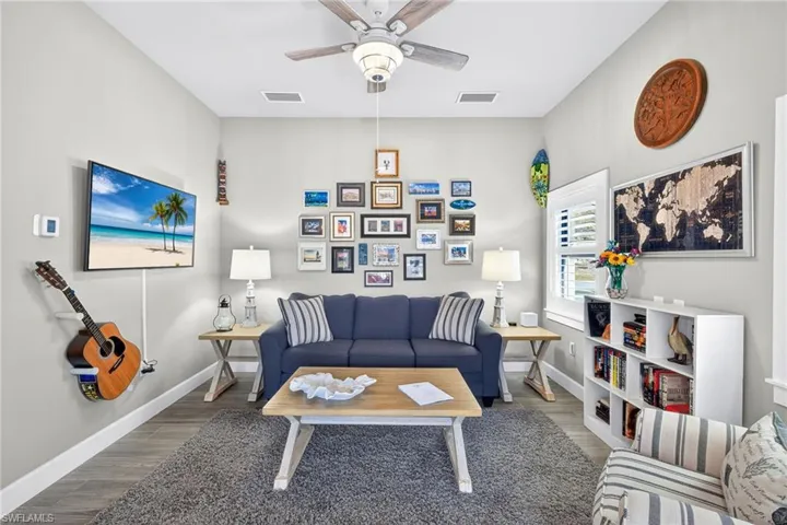 Living area featuring wood finished floors and a ceiling fan