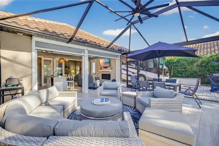View of patio with a sunroom, glass enclosure, outdoor dining area, an outdoor living space, and a ceiling fan