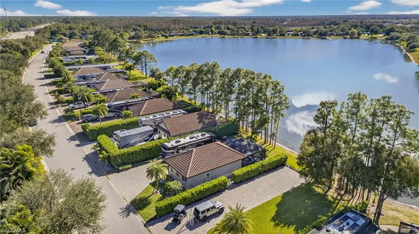 Aerial perspective of suburban area featuring a nearby body of water