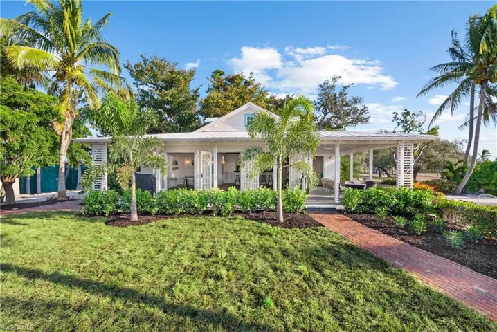 CLUBHOUSE - The Clubhouse features a white exterior, a covered porch, and a brick pathway