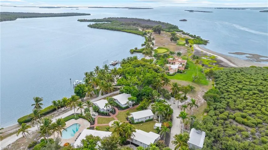 BURGESS ISLAND - The property features a private swimming pool, several buildings, and lush landscaping with palm trees