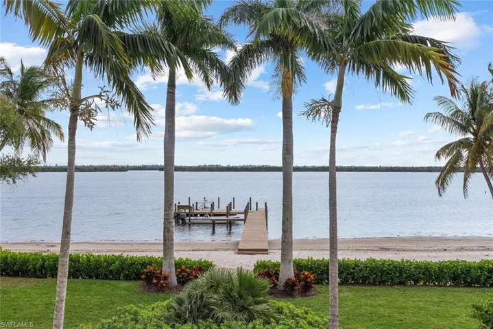 DOCK #1 - Main house private dock, sandy beach area, and mature palm trees