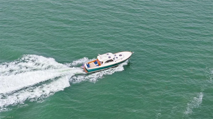 LIFESTYLE - A boat is visible on the water, featuring a white top and a teal hull