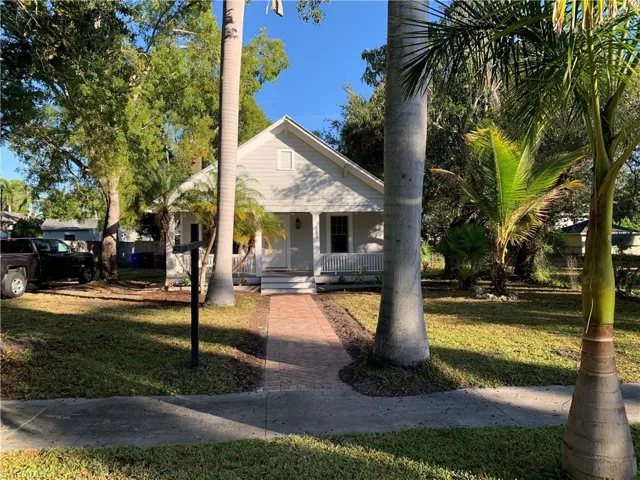 Bungalow-style house with brick walkway leading to porch
