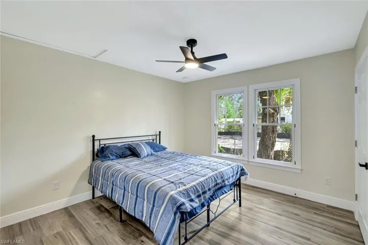 Bedroom with light wood-style floors and ceiling fan