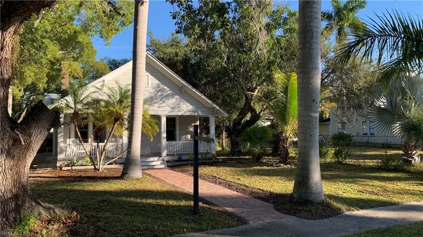 Bungalow-style home featuring covered porch and a front yard