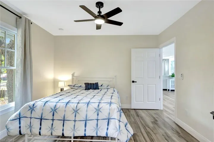 Bedroom with wood finished floors and a ceiling fan