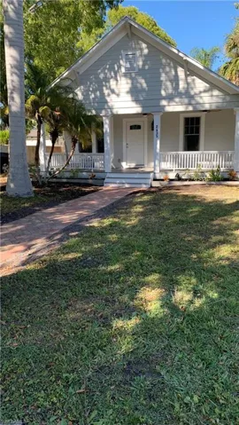 Bungalow-style house with newly paved walkway leading to porch