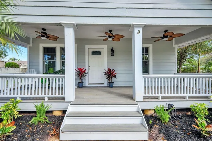 Property entrance featuring covered porch and ceiling fan