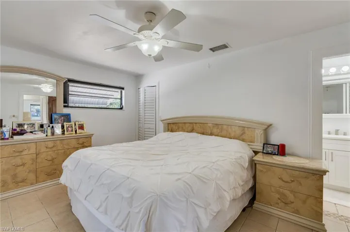 Spacious room featuring tile flooring, a window with horizontal blinds, and a ceiling fan with integrated lighting