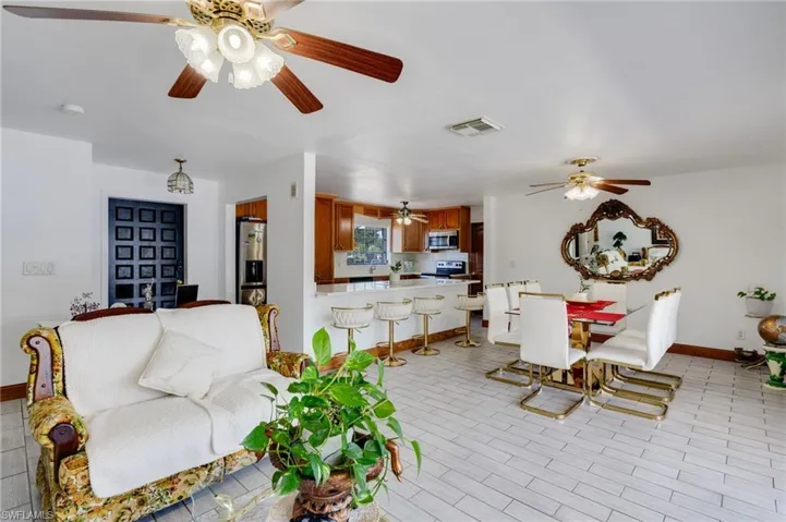 Open-concept living space with light-toned tile flooring throughout