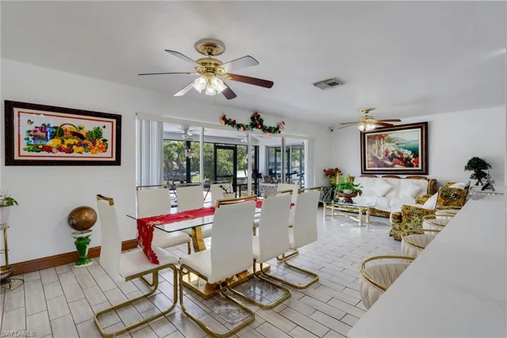 Open-concept living area with white tile flooring throughout
