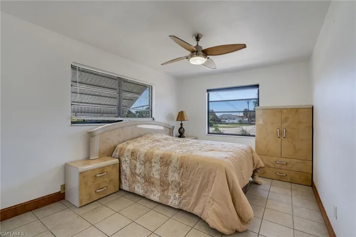 Room featuring neutral-toned tile flooring and white painted walls
