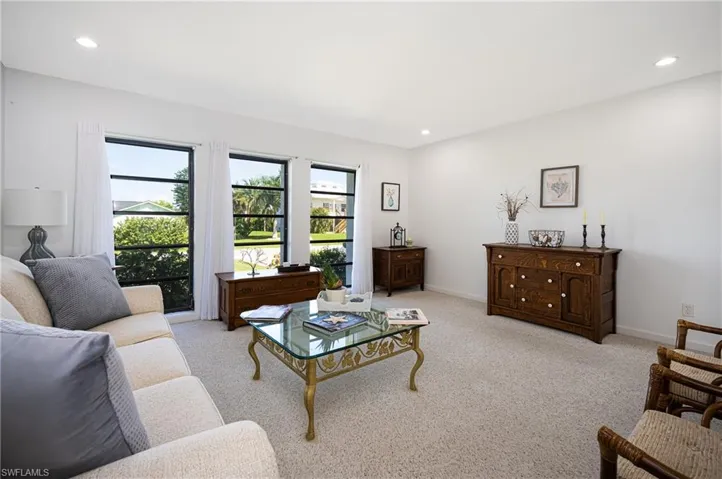 Living room featuring recessed lighting and light carpet