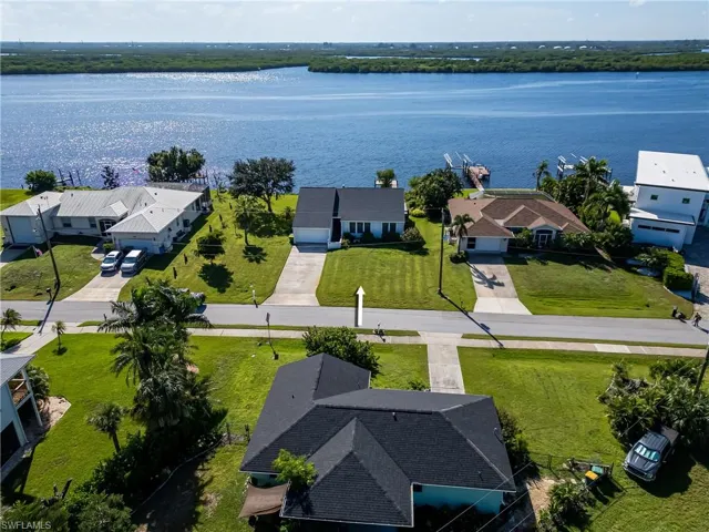 Aerial perspective of suburban area with a large body of water