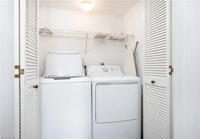 Laundry room with washer and clothes dryer