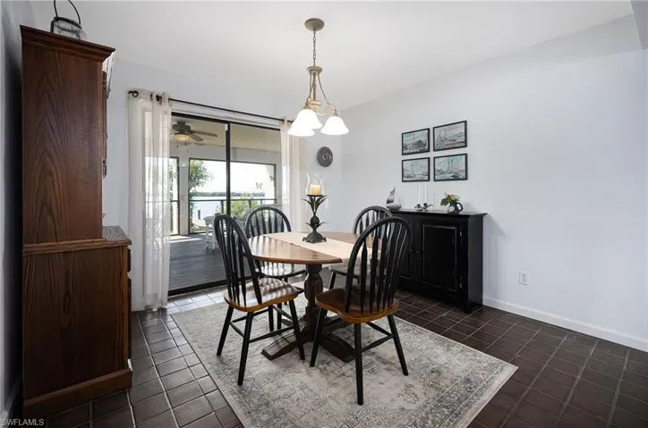 Dining room with baseboards and dark tile patterned floors