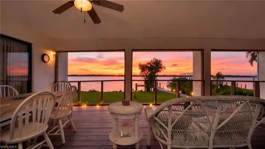 Sunroom / solarium featuring a water view and wood-type flooring