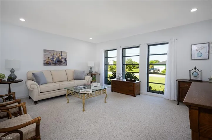 Carpeted living area featuring recessed lighting
