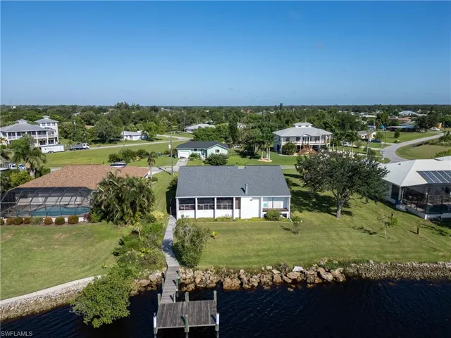 Aerial perspective of suburban area featuring a large body of water
