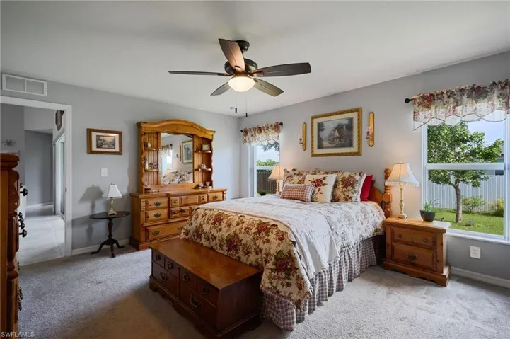 Primary bedroom featuring carpet and ceiling fan