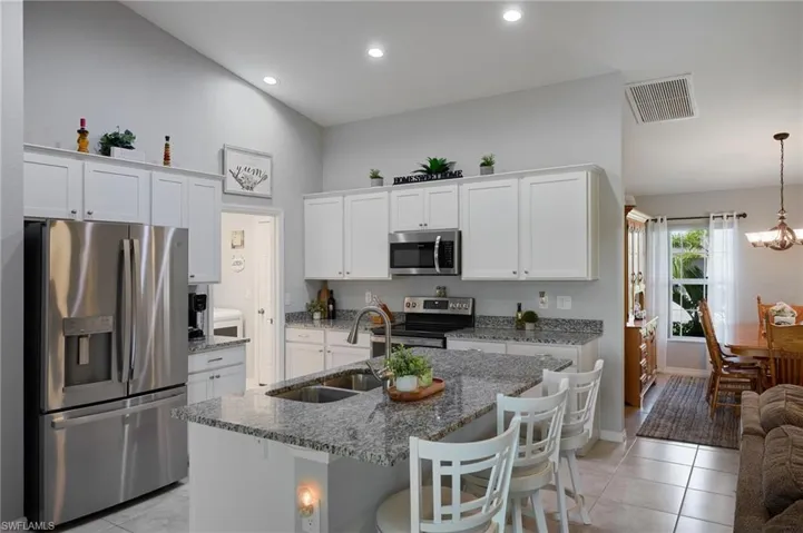 Kitchen with new stainless steel appliances, granite countertops, and lofted ceiling