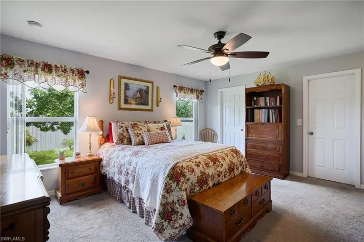 Primary bedroom featuring carpet and ceiling fan