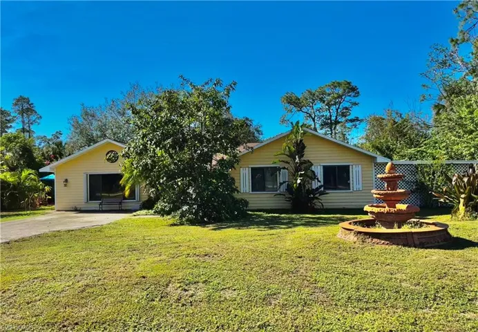 Ranch-style home featuring a front lawn