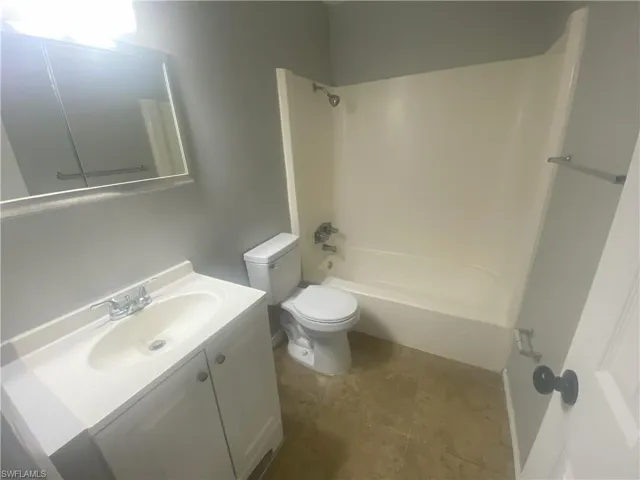 Full bath with vanity and shower / washtub combination