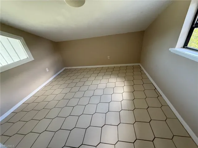 Additional living space featuring healthy amount of natural light and light floors